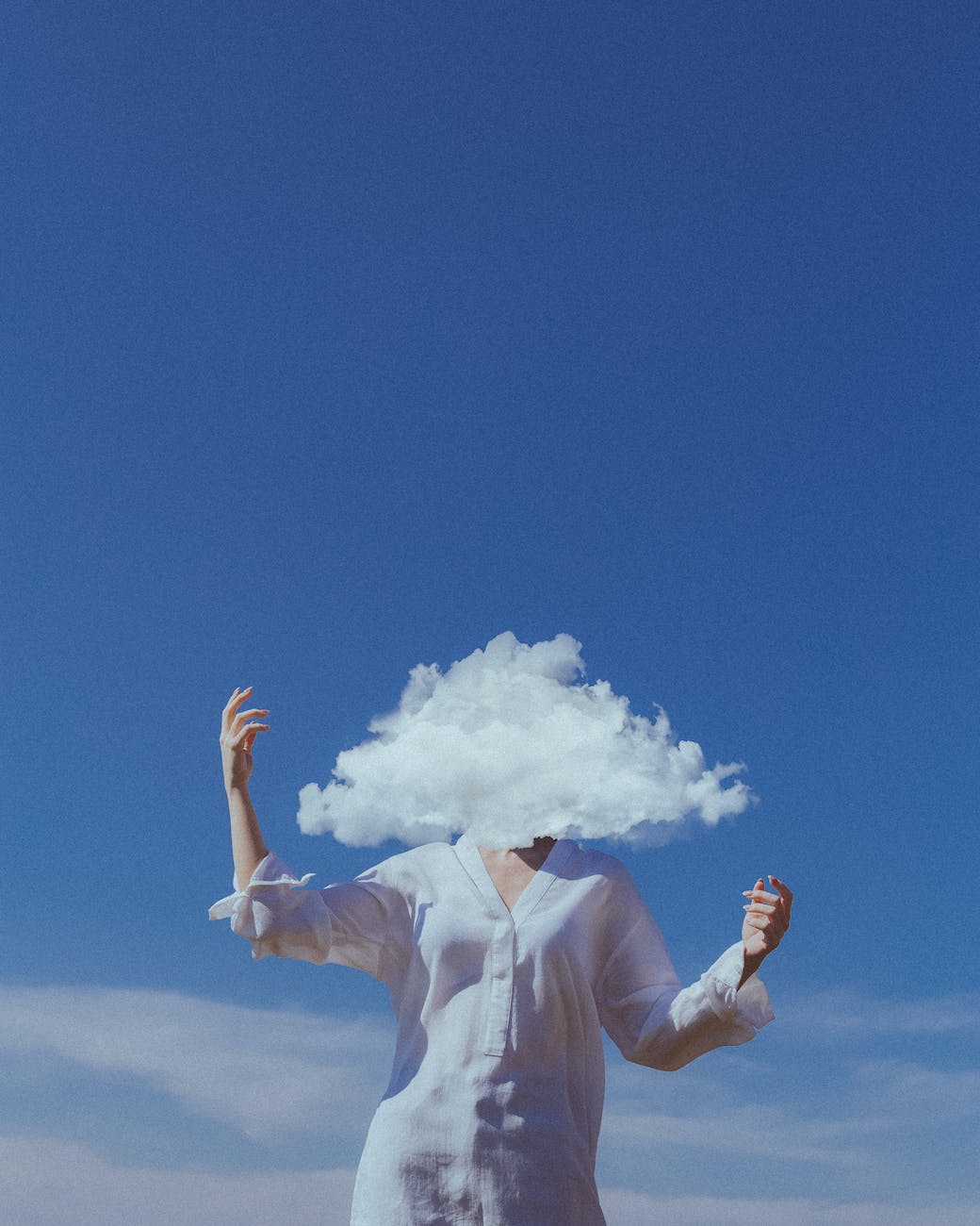 head in cloud with blue sky in background