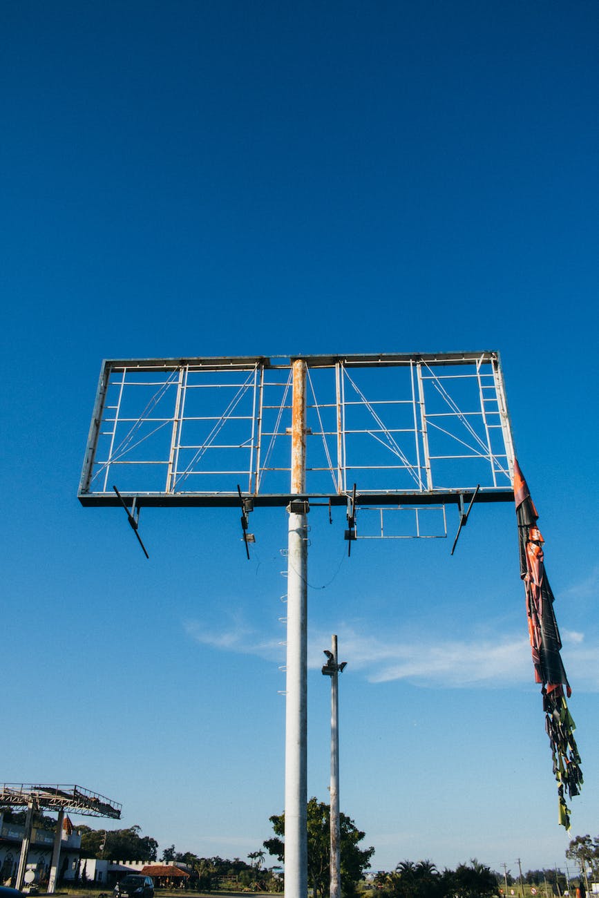 white metal billboard frame under blue sky